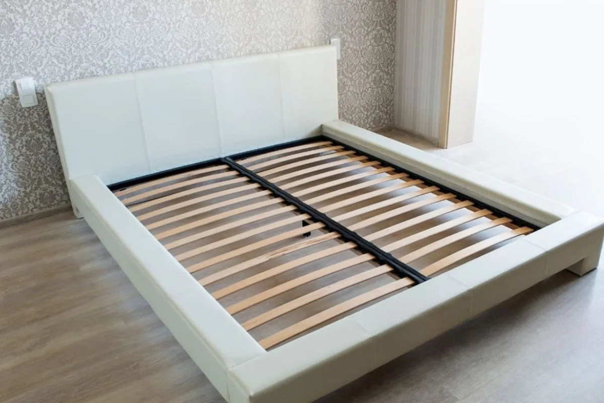 How Thick Should a Mattress Be for Stomach Sleepers? Platform bed frame with wooden slats demonstrating a supportive foundation for a mattress used by stomach sleepers
