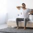 Person experiencing neck and lower back pain after sleeping, highlighting the importance of proper support for combination sleepers