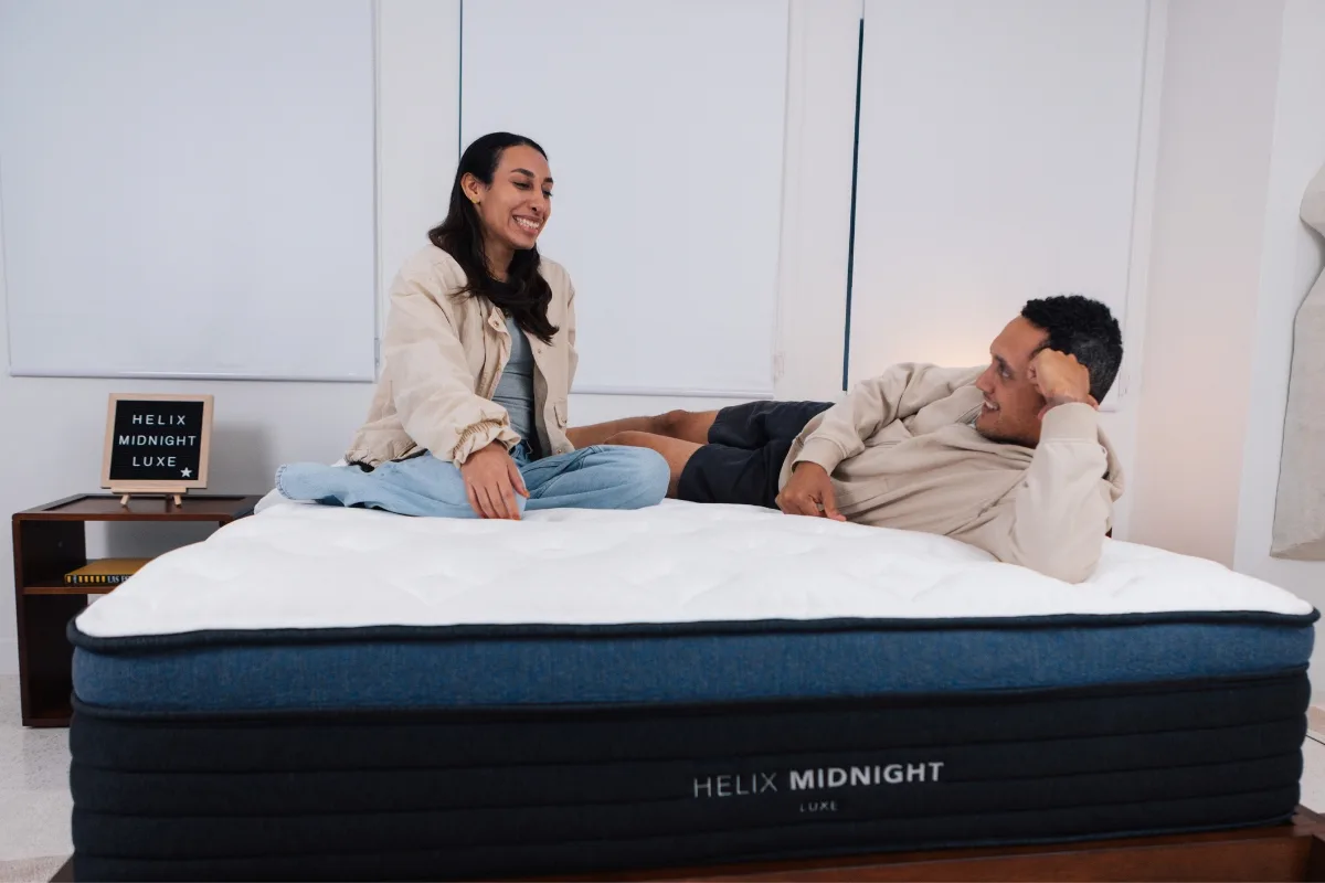 Mattress Advisory testers evaluating the comfort and motion response of a Helix Midnight Luxe mattress.